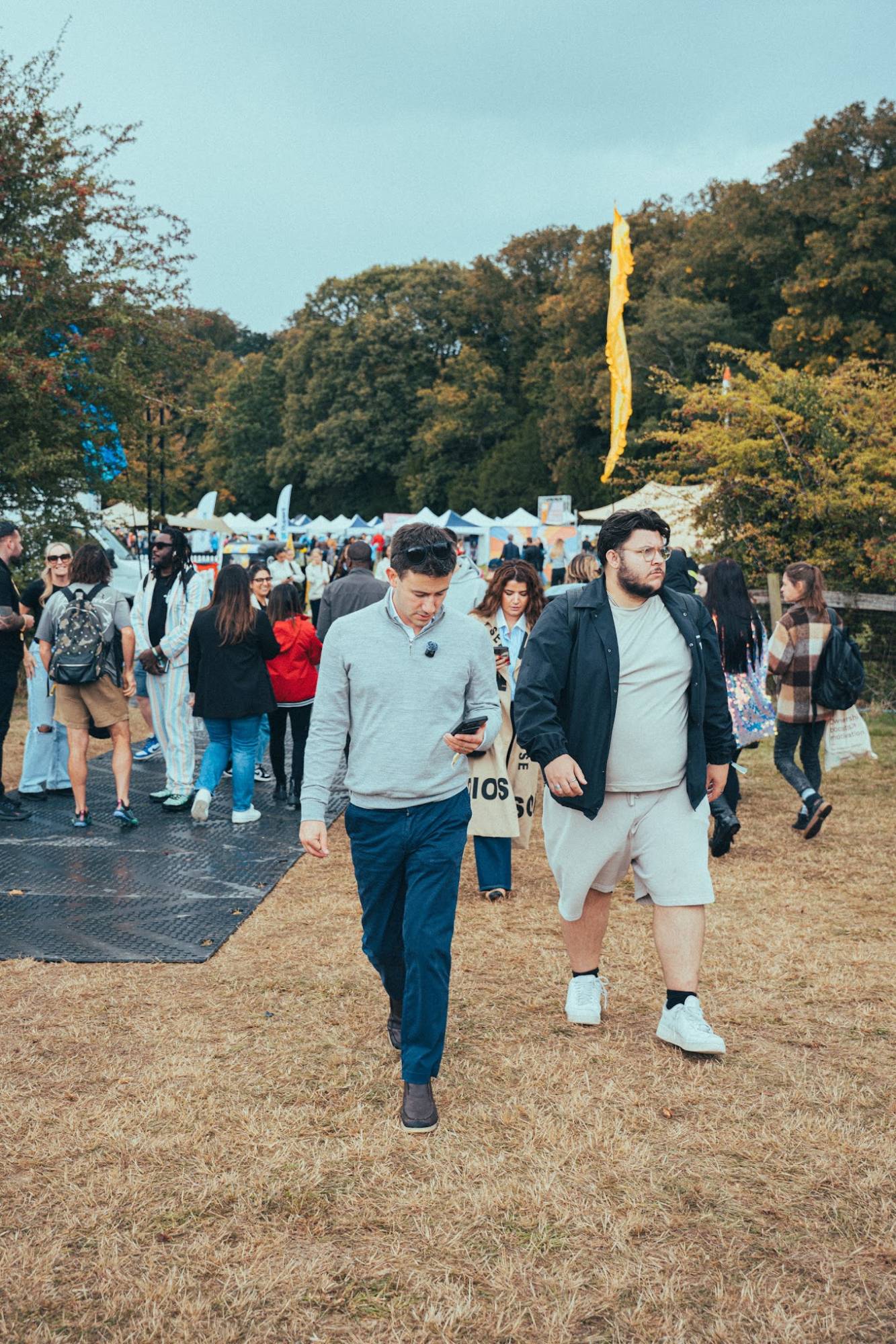 Sam Stoffel and Tom walking through a festival crowd